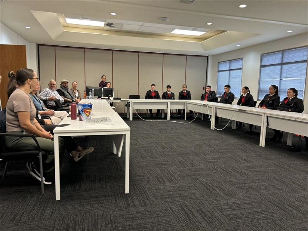 Whare Kura Visit students and staff sit in council meeting room sharing ideas