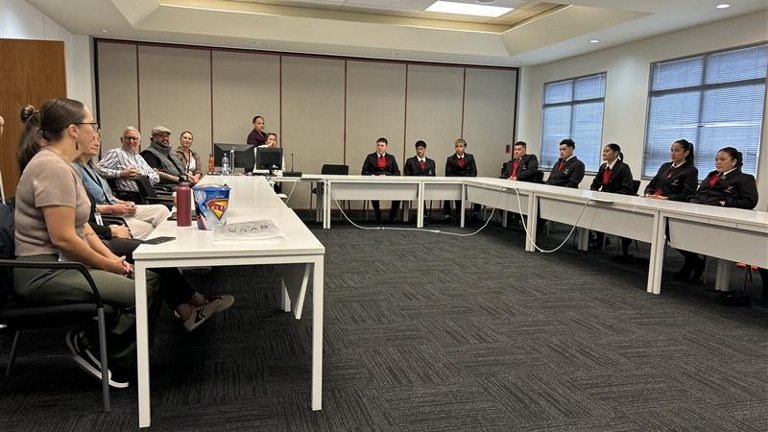 Whare Kura Visit students and staff sit in council meeting room sharing ideas