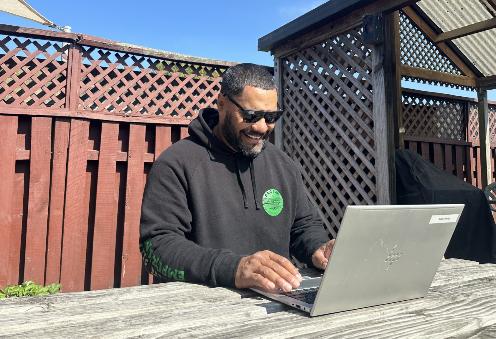 Man sitting outside on a laptop.