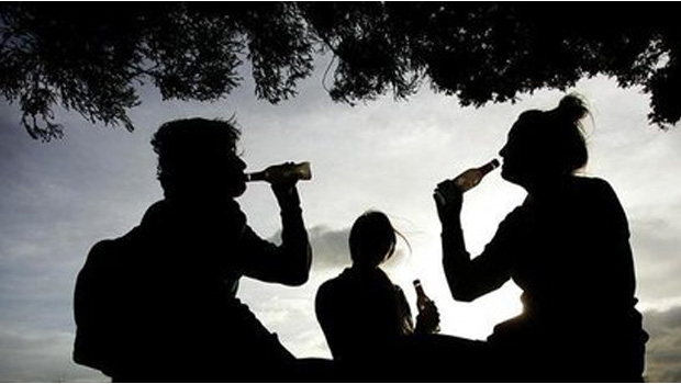 Three people drinking alcohol outside