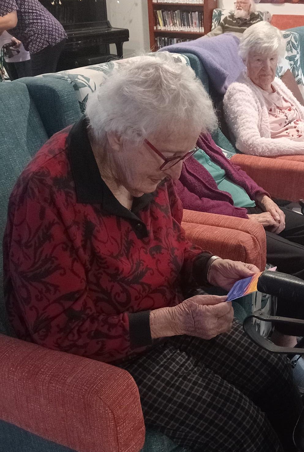 Rest home resident reads the message on the back