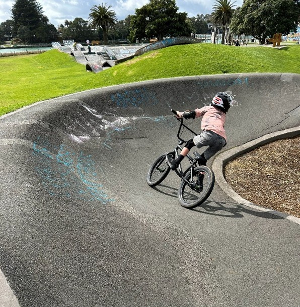 Young person on a bike on pump track
