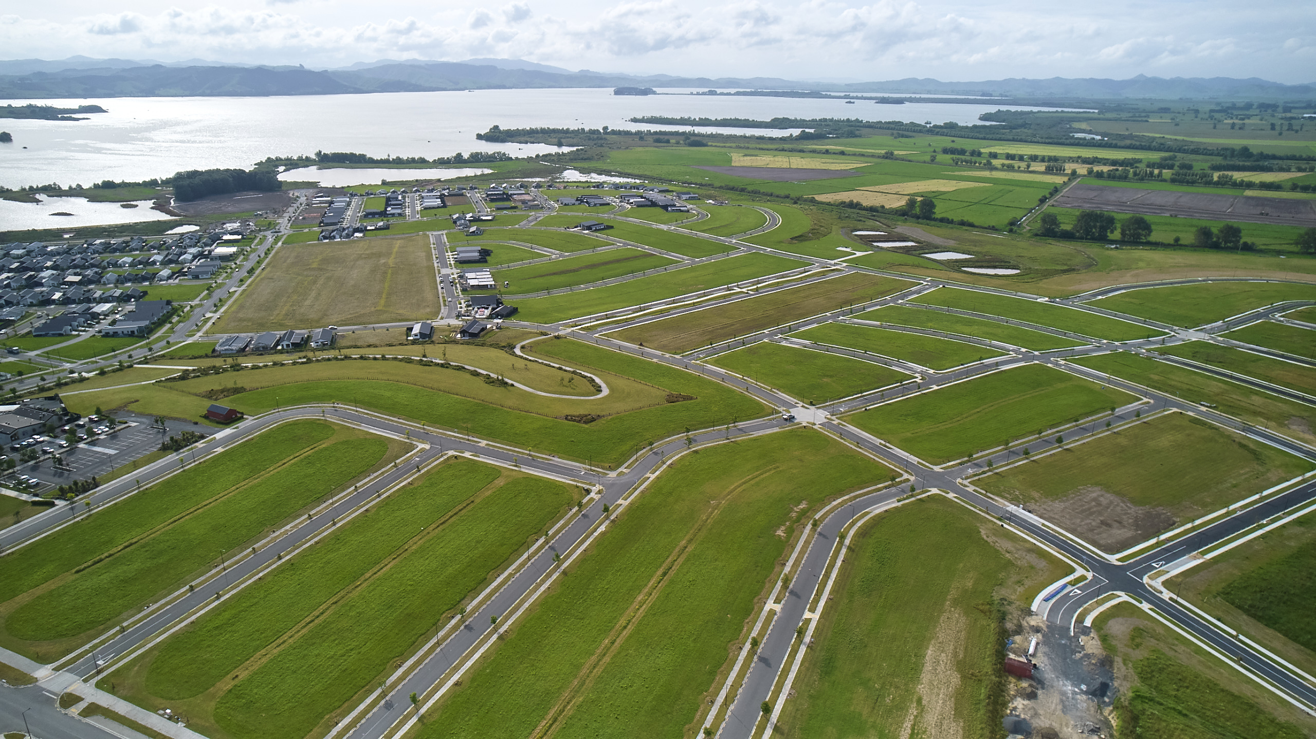 Aerial view of Te Kauwhata showing empty grass sections, with footpaths and roads